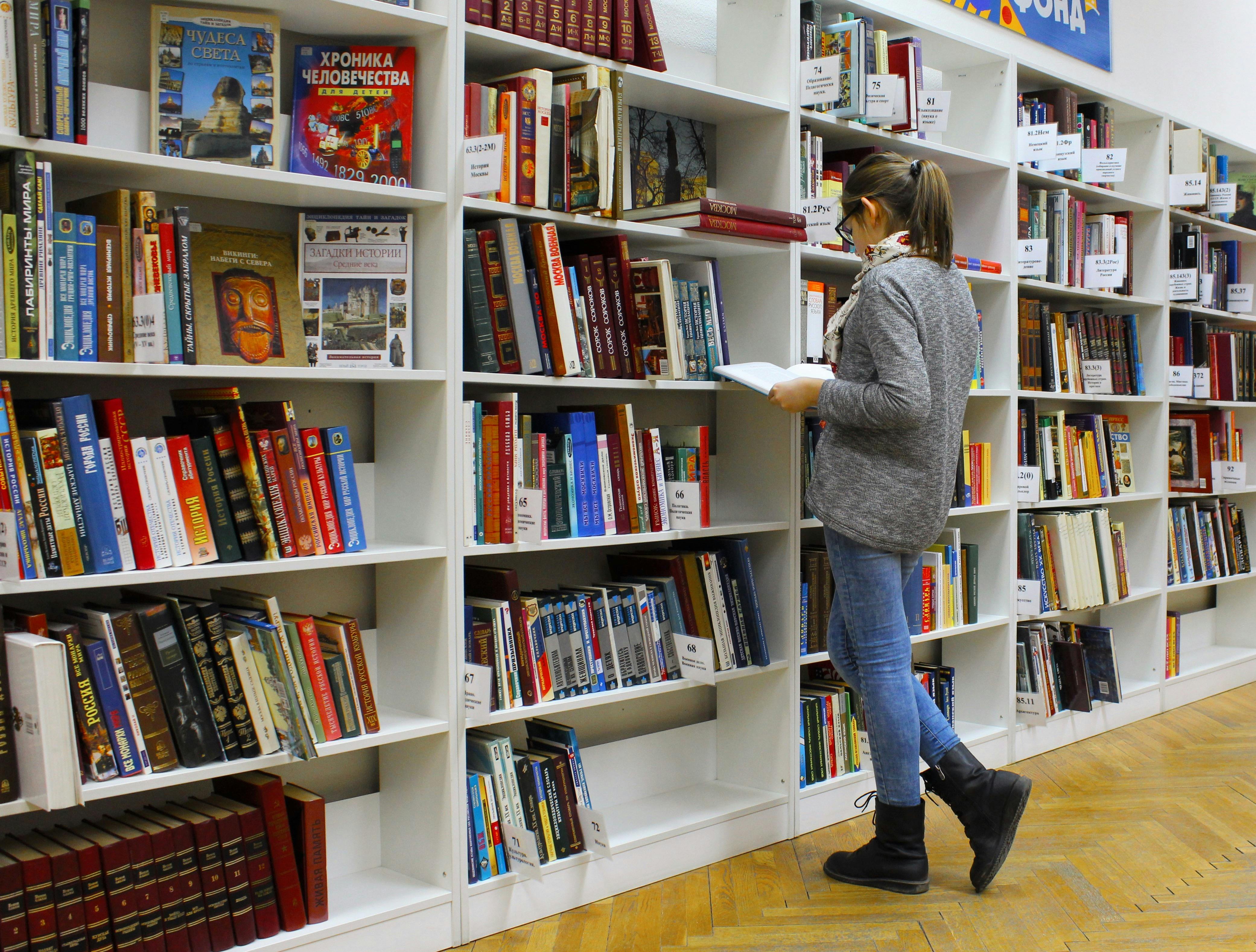 young woman reading about financial literacy 